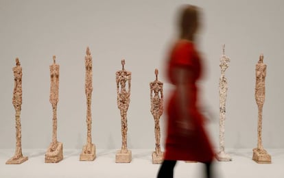 Una visitante pasea ante la serie de esculturas &#039;Mujer de Venecia&#039;, de Alberto Giacometti, en la Tate Modern de Londres.