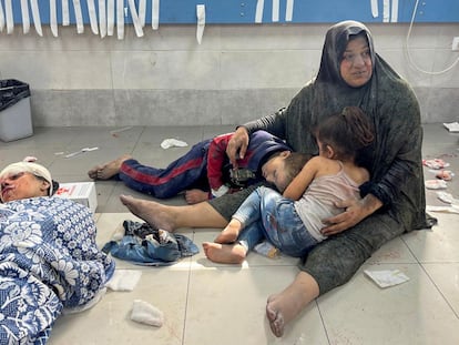 A Palestinian woman with wounded children seeks shelter from an Israeli bombing raid at Shifa Hospital in Gaza City; October 23, 2023