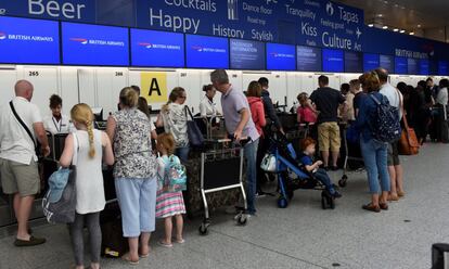 Personas esperan con su equipaje en el mostrador de facturación de British Airways en el aeropuerto de Gatwick, Reino Unido.