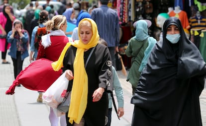 Iranian women, wearing a veil, walks among other pedestrians along a street in Tehran, Iran, in May 2023.