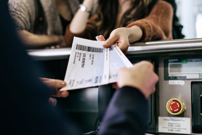 Travellers getting their boarding passes at airline check-in counter