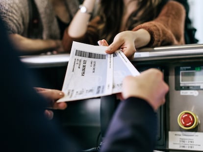 Travellers getting their boarding passes at airline check-in counter