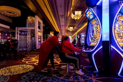 American football supporters play a slot machine in Mandalay Bay Hotel and Casino in Las Vegas, Nevada, USA, 10 February 2024.