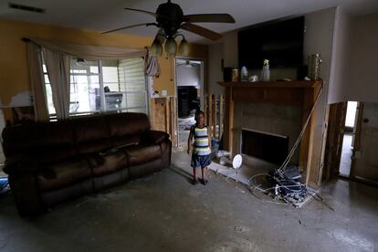 Un niño de cinco años camina por su casa dañada, en Denham Springs, Luisiana (EE.UU).