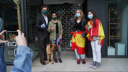 Iván Espinosa de los Monteros y Rocío Monasterio, con dos jóvenes que les han pedido una foto durante una protesta contra el Gobierno en paseo de la Habana, en Madrid, en mayo.