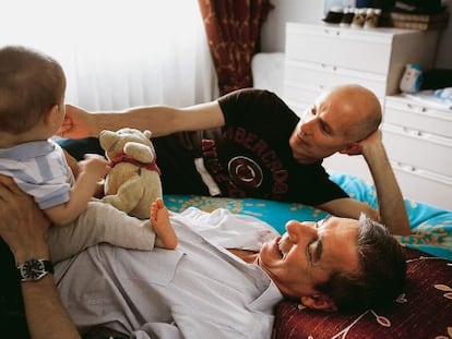 Pedro Fuentes (con su hijo Alonso encima) y su marido Javier González, hace cuatro años.