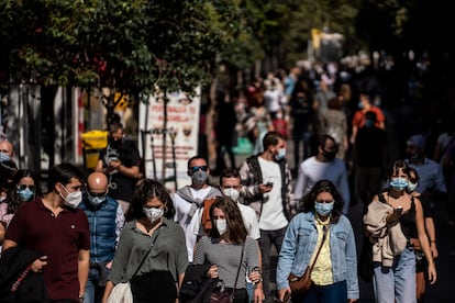 People walk through the center of Madrid after the state of alarm was introduced on Saturday.