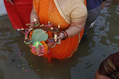 Hindu women pray to the Sun god as they stand in knee deep waters in River Ganges during the Chhath festival in Allahabad, India, Thursday, Oct.26, 2017. During Chhath, an ancient Hindu festival, rituals are performed to thank the Sun god for sustaining life on earth.( AP Photo/Rajesh Kumar Singh)