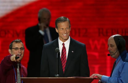 El senador republicano John Thune sigue desde el atril las indicaciones del maestro de ceremonias Howard Kolins.