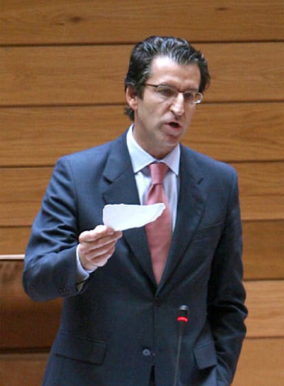 Núñez Feijóo, con el papel de la denuncia, en el Parlamento.