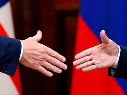 FILE - U.S. President Donald Trump shakes hand with Russian President Vladimir Putin at the end of the press conference after their meeting at the Presidential Palace in Helsinki, Finland, July 16, 2018. (AP Photo/Alexander Zemlianichenko, File)