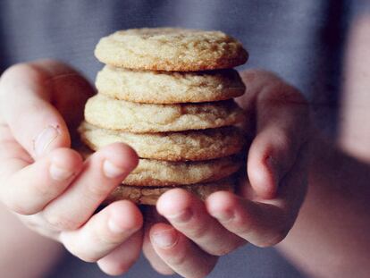 Un niño sujeta seis galletas.