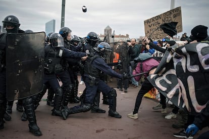 Protesters clash with police officers during a demonstration in Lyon, central France, on March 23, 2023.