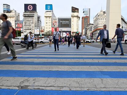 Un grupo de peatones cruza una avenida de Buenos Aires.
