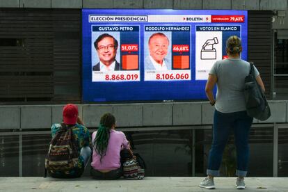 Ciudadanos miran una pantalla mostrando los resultados preliminares de la segunda vuelta de la elección presidencial, en Medellín, Colombia, este domingo 19 de junio.
