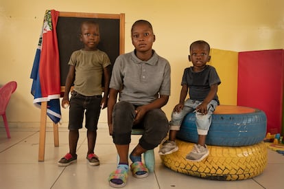 Esther, 22, with her two children, Roben, five, and Robenson, four. They live in the Waff Jeremie neighborhood.