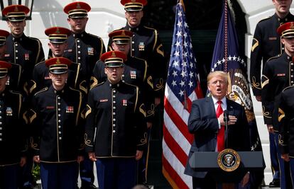 El presidente estadounidense, Donald Trump, se lleva la mano al corazón y canta el Himno Nacional de Estados Unidos junto a miembros del ejército en la Casa Blanca.