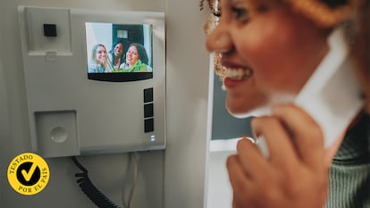 Una chica abriendo a sus amigas mediante el videoportero.