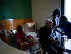 A nurse administers the Pfizer-BioNTech COVID-19 vaccine to a resident at the Icaria nursing home in Barcelona, Spain, Tuesday, Feb. 2, 2021. Spain's top coronavirus expert suggests that the coronavirus vaccine manufactured by AstraZeneca should be administered to young people given the lack of evidence on how it performs with older adults. (AP Photo/Emilio Morenatti)