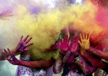 Un grupo de estudiantes indias se lanzan polvos de colores con motivo de la celebración del festival Holi, en Bhopal (India).