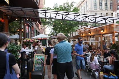 Customers wait to get a table at a Manhattan restaurant on May 23, 2021, as New York City eased Covid-19 restrictions.