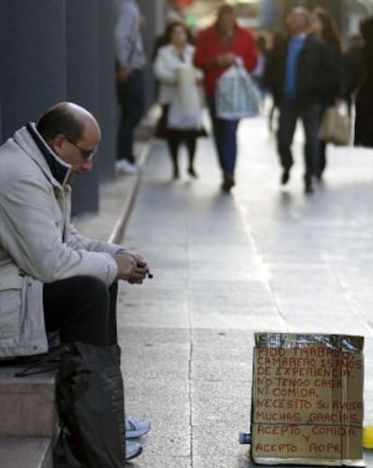 An out-of-work waiter begging on the streets of Valencia.
