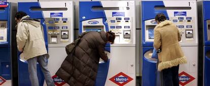 Usuarios del metro compran sus billetes en las taquillas.