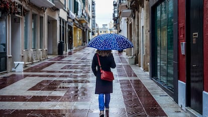 A woman with an umbrella in Mahón Menorca