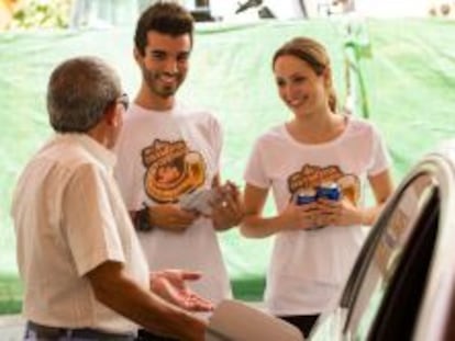 Participantes en la campa&ntilde;a En la carretera, cerveza sin de 2013 conversan con un conductor.