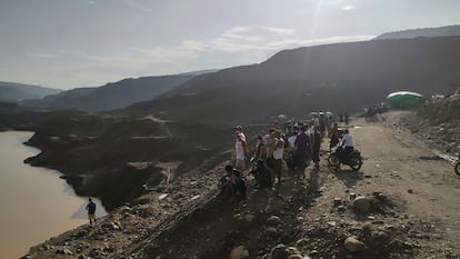 Miners, rescuers and local residents look at the jade mine site where a landslide accident took place in Hpakant township, Kachin state, Myanmar