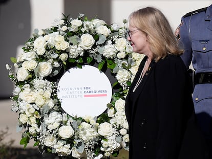 Amy Carter walks past a wreath honoring her mother during a wreath laying ceremony at the Rosalynn Carter Health & Human Services complex on the campus of Georgia Southwestern State University in Americus, Georgia, Nov. 27, 2023.