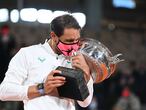 Spain's Rafael Nadal kisses the Mousquetaires Cup (The Musketeers) as he celebrates during the podium ceremony after winning the men's singles final tennis match against Serbia's Novak Djokovic at the Philippe Chatrier court, on Day 15 of The Roland Garros 2020 French Open tennis tournament in Paris on October 11, 2020. (Photo by Anne-Christine POUJOULAT / AFP)