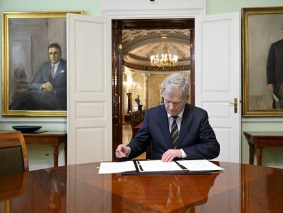 Finnish President Sauli Niinisto signs Finland's National NATO legislation in Helsinki on March 23, 2023.