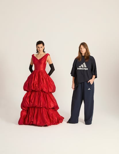 Nine d'Urso poses with Bina Daigeler, the costume designer for the 'Balenciaga' series. The actress wears a reproduction of a ruffled evening dress that Balenciaga showed in 1952. Daigeler wears a Balenciaga x Adidas T-shirt and tracksuit pants, created by Demna Gvasalia, the current creative director of the House of Balenciaga.