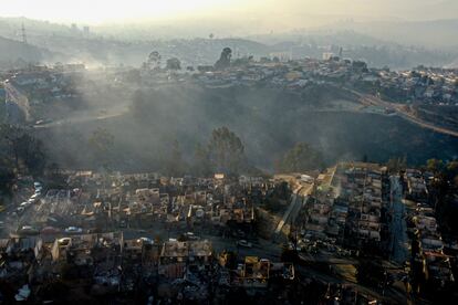 Smoke raises from  burnt-out houses after a forest fire reached Villa Independencia neighborhood in Vina del Mar, Chile, Saturday, Feb. 3, 2024