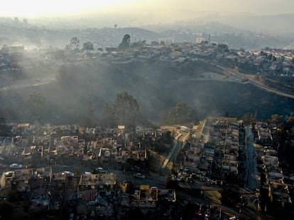 Smoke raises from  burnt-out houses after a forest fire reached Villa Independencia neighborhood in Vina del Mar, Chile, Saturday, Feb. 3, 2024.