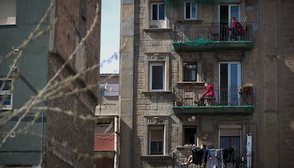 Diverses persones als balcons de casa seva, a la Barceloneta.