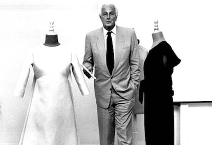 Hubert de Givenchy posa entre dos diseños de Balenciaga, durante un curso de verano en la Universidad de San Sebastián, en 1955.