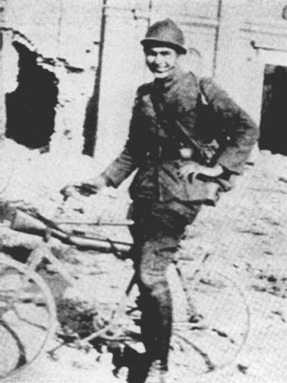 Ernest Hemingway con su bicicleta en Fossalta, frente a las ruinas de la iglesia.