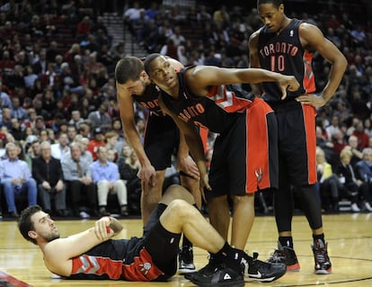 Andrea Bargnani se agarra el codo tras una caída, mientras sus compañeros lo rodean.