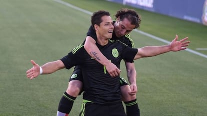 Chicharito Hernández es abrazado por Guardado en una partido de la selección mexicana.