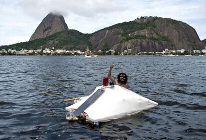 Hamilton Cunha Filho, una persona sin hogar, saluda desde su casa flotante construida con basura en la bah&iacute;a de Guanabara en R&iacute;o de Janeiro, Brasil