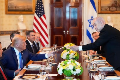 El primer ministro israelí, Benjamin Netanyahu, entrega un documento al presidente estadounidense, Donald Trump, en la Casa Blanca.