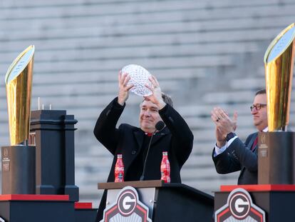 Georgia Bulldogs head coach Kirby Smart holds up the coaches trophy at the national championship celebration at Sanford Stadium.