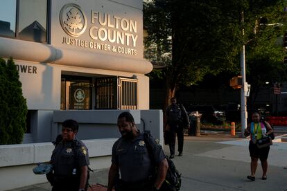 People walk past the Lewis R. Slaton Courthouse after a Grand Jury brought back indictments against former president Donald Trump