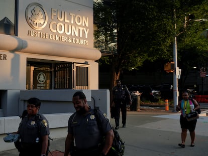 People walk past the Lewis R. Slaton Courthouse in Atlanta, Georgia, on August 15, 2023.