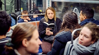A woman reads on the Paris metro, in a photo from March 2025.