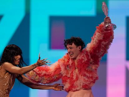 Nemo of Switzerland, who performed the song The Code, celebrates with last year's winner Loreen of Sweden after winning the Grand Final of the Eurovision Song Contest in Malmo, Sweden, Saturday, May 11, 2024. (AP Photo/Martin Meissner)