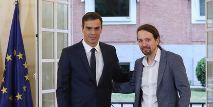 Pablo Iglesias firma el acuerdo sobre el proyecto de ley de presupuestos para 2019 en el Palacio de la Moncloa ante la mirada del presidente, Pedro Sánchez.