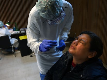 A healthcare worker conducts an antigen test during a mass coronavirus screening at Santa Creu i Sant Pau Hospital in Barcelona.